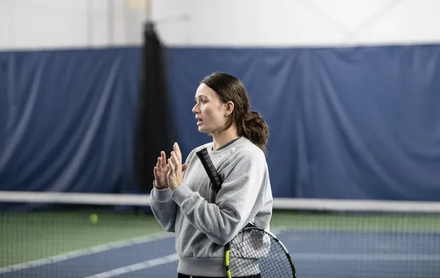 A coach explaining a drill on an indoor court